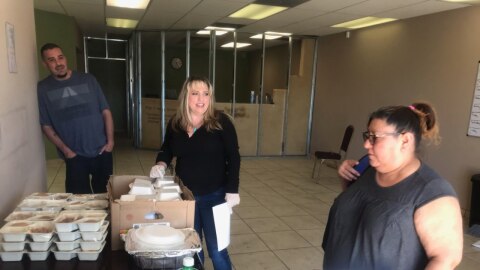 Ronnie Flores, shelter manager Shannon Baum and Brenda Marquez Duran prepare to distribute food and hygiene items in March 2020.