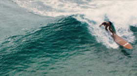 Duane DeSoto surfing on a replica of Duke Kahanamoku's longboard. Photo courtesy of Sidewinder Films. 