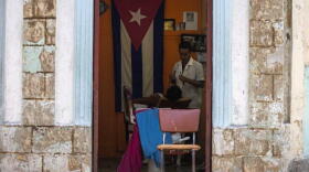 A Cuban barber shaves a customer at his privately owned business in Havana.
