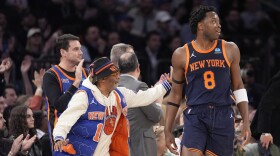 Filmmaker Spike Lee, left, pats New York Knicks forward OG Anunoby (8) on the back after Anunoby scored a 3-point basket against the Philadelphia 76ers during the first half of an NBA basketball game Tuesday, March 12, 2024, at Madison Square Garden in New York. (AP Photo/Mary Altaffer)