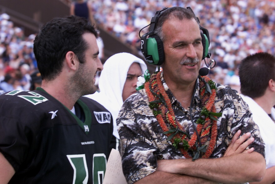 FILE - Hawaii coach June Jones and quarterback Nick Rolovich laugh during the fourth quarter action at Aloha Stadium in Honolulu on Dec. 8, 2001.
