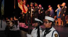 Uniformed service members salute the flag during 9-11 ceremony in the City of Clermont.  Photo: Jason Delgado
