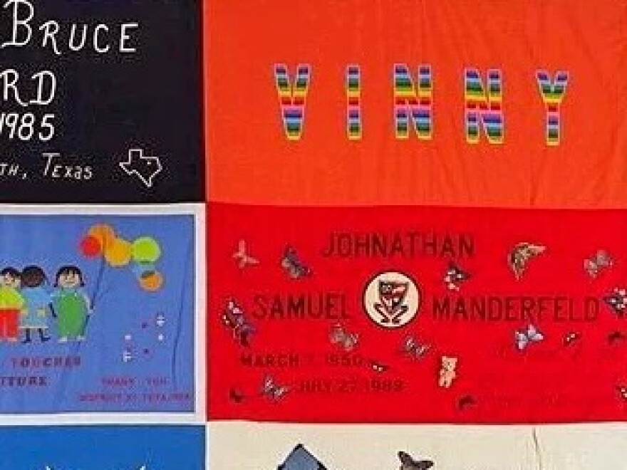 a close-up of a colorful quilt. in the top right corner is the name 'vinny' written in rainbow letters
