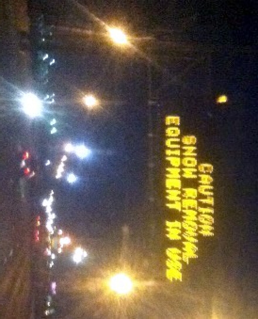 Sign over Highway 169 warns motorists of snow plows ahead.