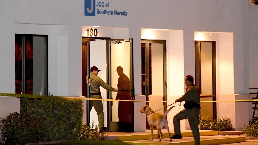 Las Vegas Metropolitan Police Department K-9 officers search the Jewish Community Center of Southern Nevada after an employee received a suspicious phone call that led to the evacuation of about 10 people from the building on Feb. 27. A suspect in Israel has been arrested in connection with the waves of bomb threats like this one.