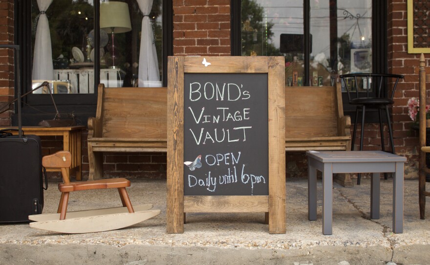 A chalk sign advertising Bond's Vintage Vault, a permanent storefront opened by a Gainesville resident to capitalize on the town's steady stream of tourism.