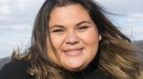 Headshot of journalist Olivia Ali. She is looking toward the camera and smiling.