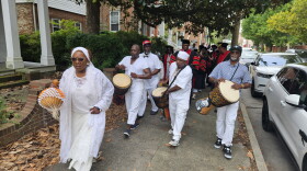 Nana Mayla leads a procession to Long Warf in Cambridge