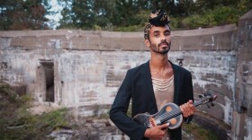 Jake Blount, holding an electric violin