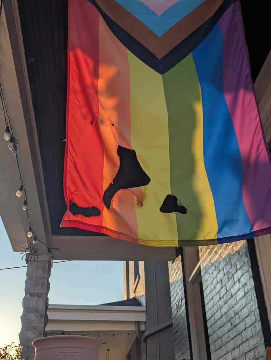 Photo of a flag with burn marks in Northside
