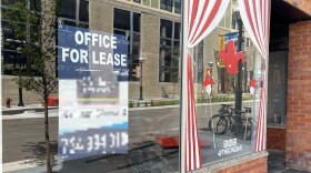 A picture of an empty storefront window and an add that says "office space for lease". 