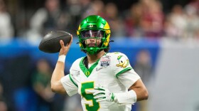 Oregon quarterback Dante Moore prepares to pass a ball.
