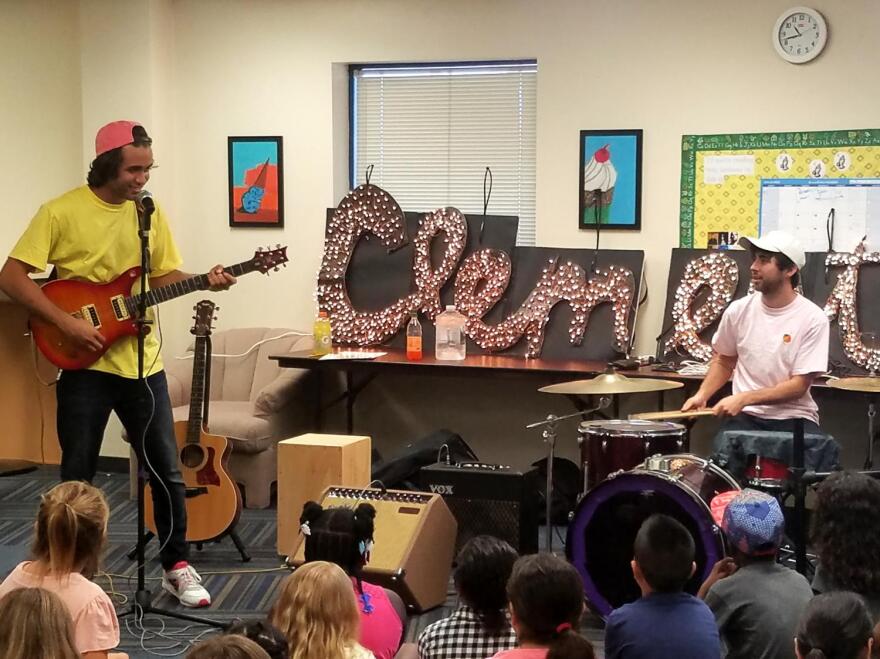 musicians showing kids how they play instruments