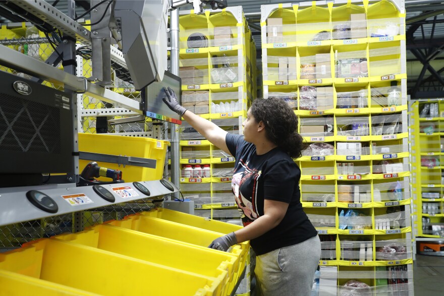 A worker sorts through items and places orders at the Amazon Fulfillment Center in Staten Island in New York. 
