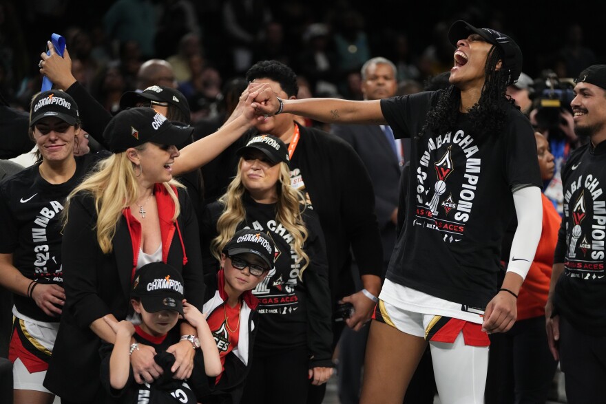 Las Vegas Aces' A'ja Wilson, right, celebrates with teammates after Game 4 of a WNBA basketball final playoff series against the New York Liberty Wednesday, Oct. 18, 2023, in New York. The Aces won 70-69. (AP Photo/Frank Franklin II)