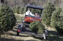 Bobby Maines, left, rides with his grand-daughter, Alyssia Maines, 6, right, as they carry a Christmas tree for a customer at Maines Tree Farm in Glade Valley, N.C., Friday, Dec. 2, 2011