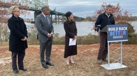 Cape Fear River Keeper Kemp Burdette stands at a lectern to address recent funding to mitigate PFAS in drinking water. He's joined (left to right) by Representative Deb Butler, Wilmington Mayor Bill Saffo, and and North Carolina Democratic Party Chair Bobbie Richardson.