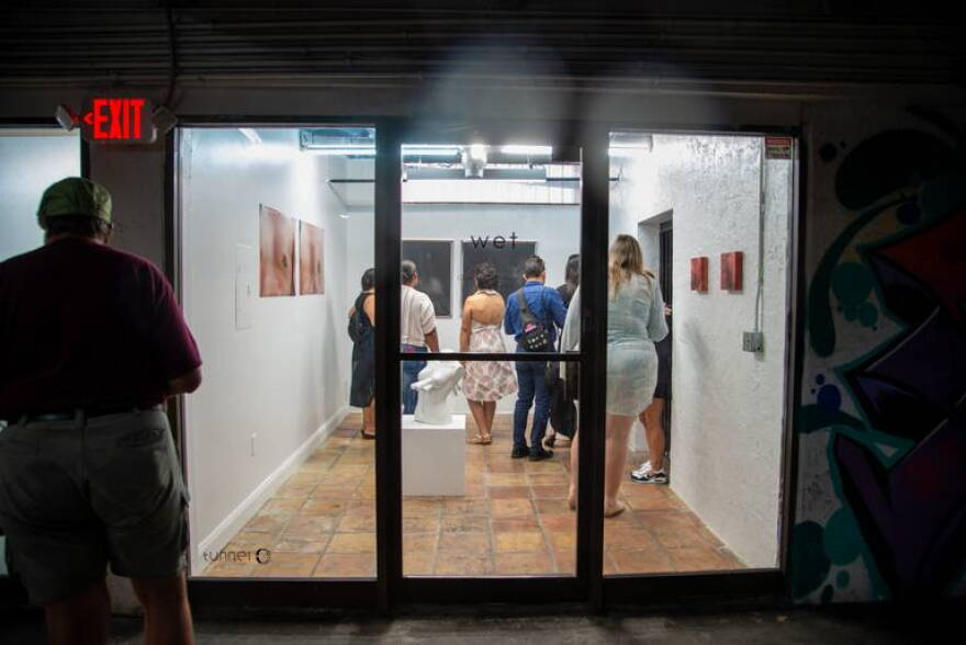 Guests attend an art exhibition at Tunnel, an art collective in Little Havana.