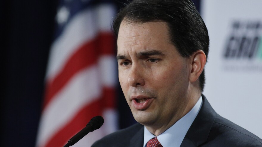 Elsewhere at the Capitol and with little fanfare, Gov. Scott Walker signed a bill Monday making Wisconsin a "right to work" state.