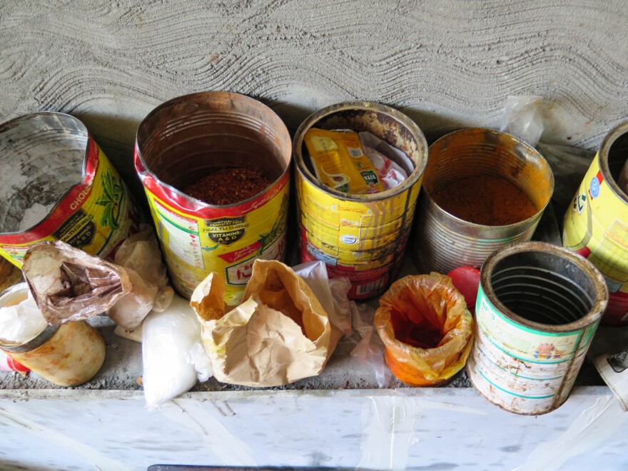 Tin cans and grubby little bags found during Ayesha Mumtaz's raid of a backstreet sweets factory in Lahore, Pakistan.