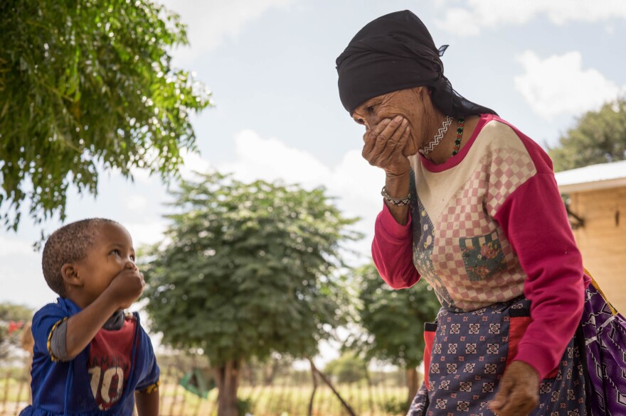 A grandmother and granddaughter in Namibia share a joke. They are members of the Khoisan group.