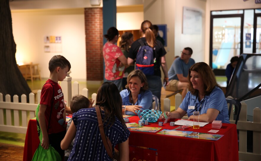 Visitors stop at the Head Start partner table at Be My Neighbor Day with WKAR.