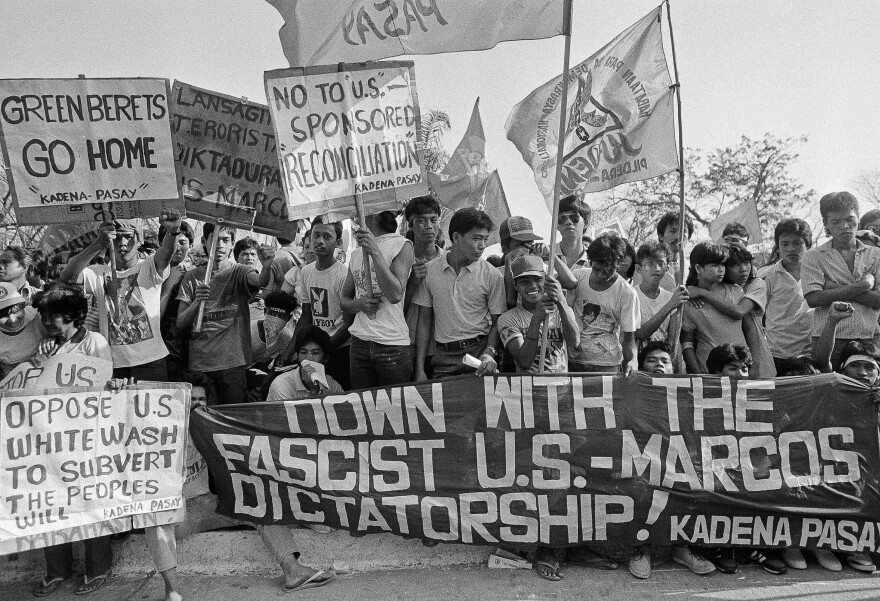 FILE — An estimated 3,000 students and workers demonstrate in Manila, Philippines, Feb. 18, 1986, against the Marcos government and the U.S. government's support of Marcos.