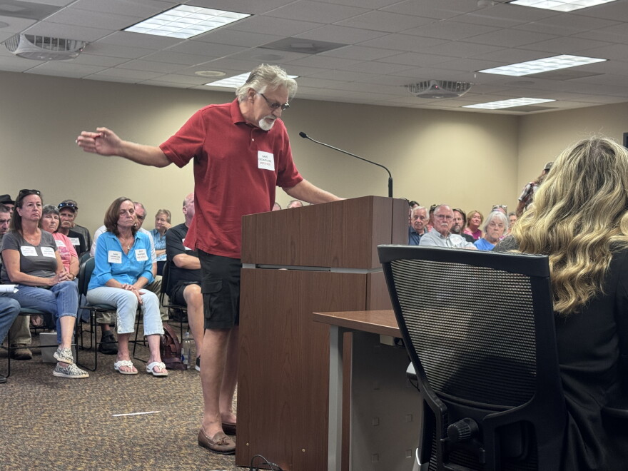 Cedar Lake resident Don Machacek spoke at an Oklahoma Water Resources Board meeting in July, asking the board to order water released from Coffee dam No. 6. Behind him, his neighbors packed the meeting room.
