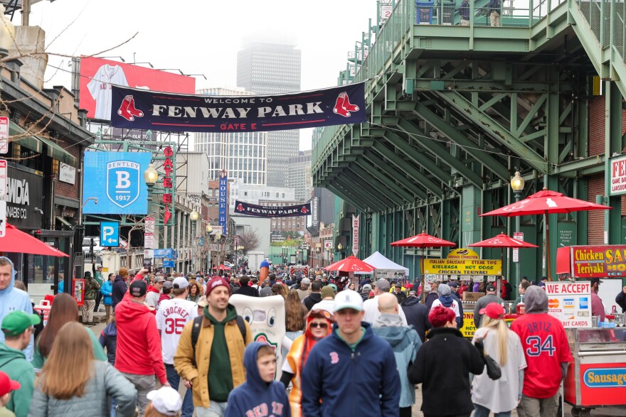 Van Baburins, from west Medford poses for a photo with his dog, JoJo, ahead of the home opener game outside Fenway Park on April 3, 2026. Baburins who goes by Van The Guitar Man attends every opening day with his guitar.