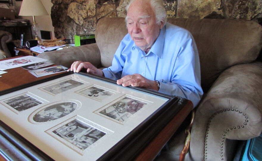 Henry Chamberlain looks at mementos from World War II. He spent three and a half years as a prisoner of the Japanese.