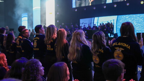 Oklahoma FFA members stand and cheer at the 99th National FFA Convention & Expo in Indianapolis.