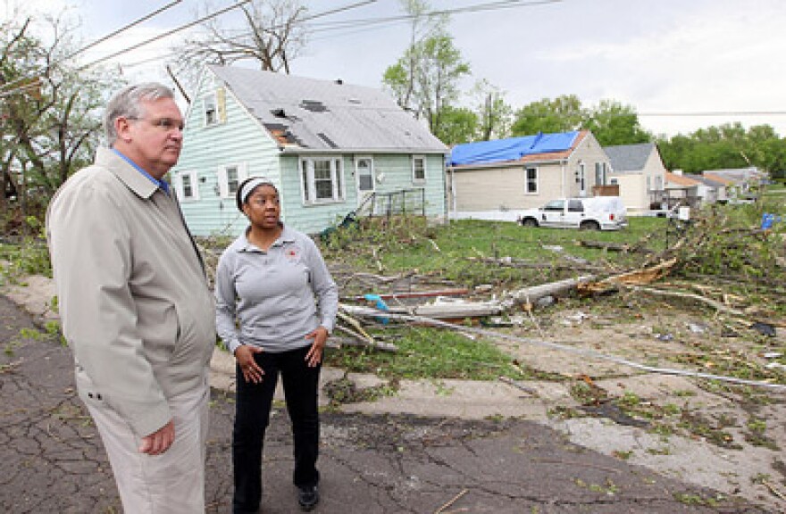 Mo. Gov. Jay Nixon gets a tour of a damaged neighborhood by Berkeley, Mo. Mayor Kyra Watson in St. Louis on April 23, 2011. A F-4 tornado hit the region on April 22. The White House has issued a disaster declaration for portions of Missouri today.