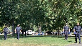Medford police at Hawthorne Park on Tuesday while an encampment was being cleared. 