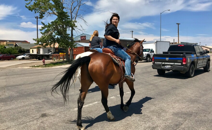 Jonnilyn Loring leads a group of marchers down the main highway in Browning, Mont.