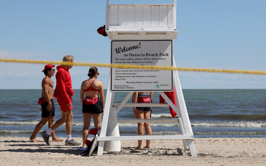 Ontario Beach Park was closed to swimmers Tuesday, June 22, due to an algae bloom that made the water unsafe for bathing. Lifeguards patrolled the beach to keep people out of the water and a frontloader pushed algae along the beachfront to a pump that dumps it into the Genesee River on the other side of the Charlotte Pier at the park.