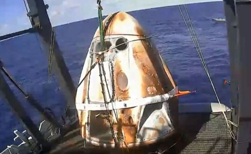 The Crew Dragon capsule was fished out of the Atlantic Ocean off the Florida coast shortly before 10 a.m. ET Friday, with its surface bearing the scorch marks of its fiery re-entry.