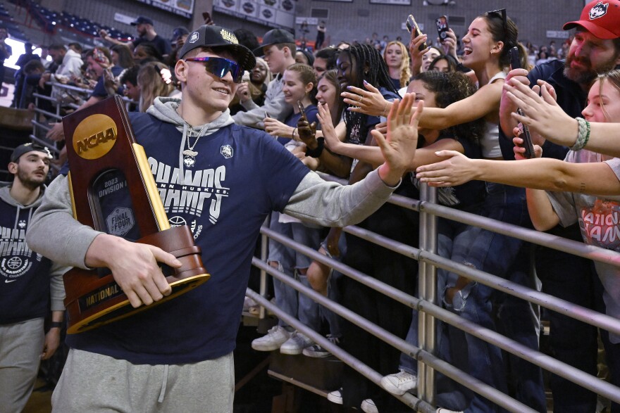 UConn's Donovan Clingan is greeted by fans as the team arrives for a rally at Gampel Pavilion in honor of UConn's NCAA men's Division I basketball championship, Tuesday, April 4, 2023, in Storrs, Connecticut.