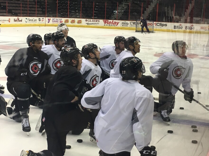 Players get coaching advice at a practice just before their last regular season game.