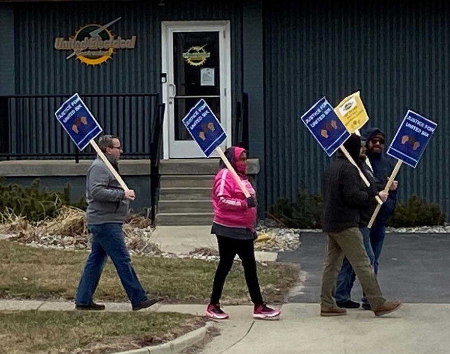 Former employees of United Electrical Contractors, Inc. protest outside the company's main office in Lansing. Nine plaintiffs are suing the company for racial and sexual harassment.