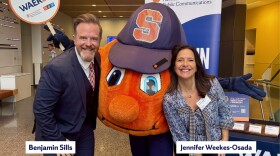 WAER Development Team, Benjamin Sills and Jennifer Weekes-Osada, with Otto the Orange holding a WAER sign at the WAER Hall of Fame