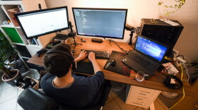 A computer scientist works in his home office  (Ina Fassbender/AFP via Getty Images)