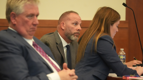 Jason Meade, center, sits with his attorneys Mark Collins, left, and Kaitlyn Stephens, right, during opening statements in the retrial of the former Ohio sheriff's deputy charged with murder and reckless homicide in the 2020 killing of Casey Goodson Jr., inside Franklin County Common Pleas Court in Columbus, Ohio, Thursday, April 23, 2026.