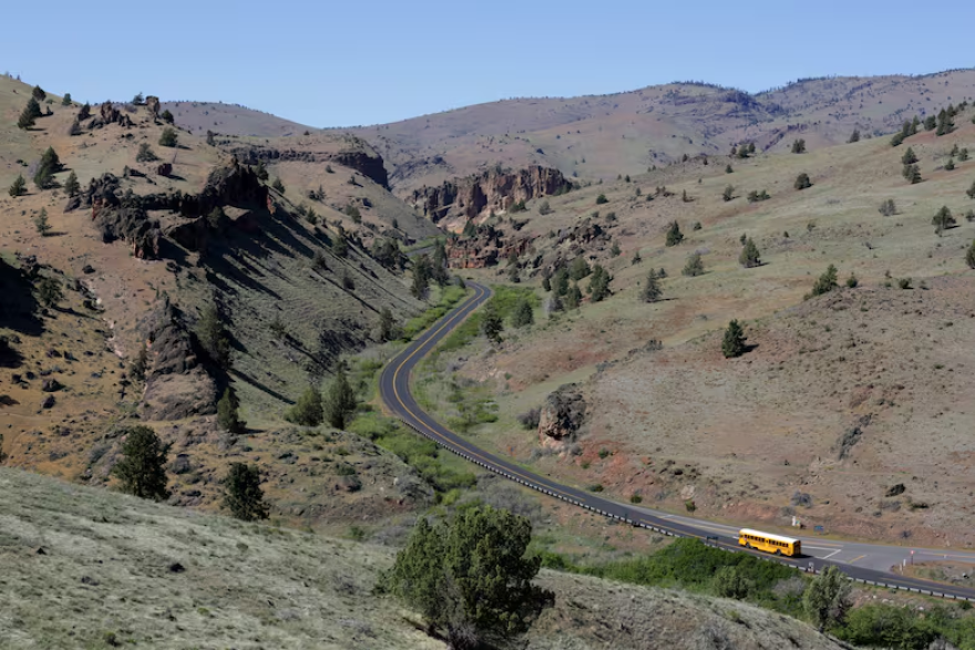 A school bus drives out the long road towards Simnasho in the Warm Springs Reservation in Oregon .