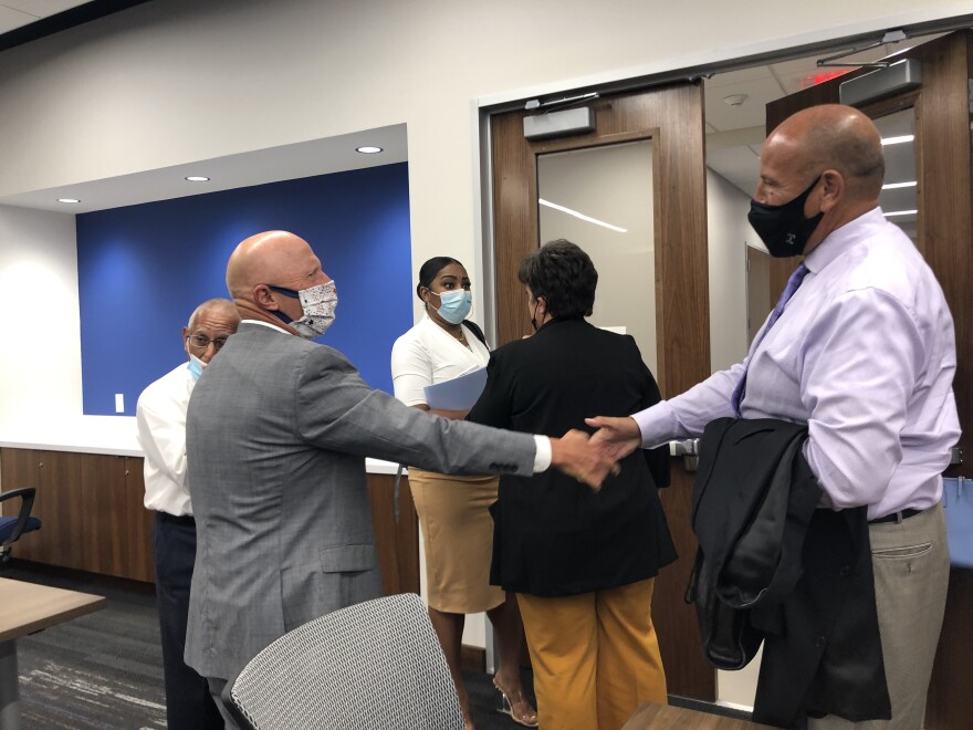 SAISD Trustee Ed Garza shakes hands with Robert Jaklich to welcome him as the district's interim superintendent.