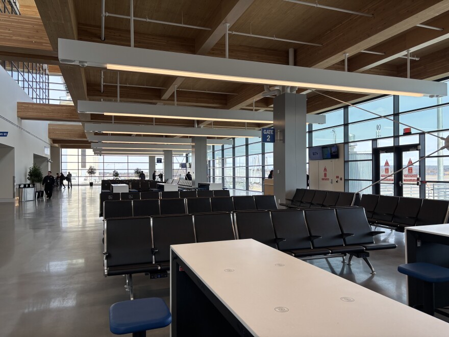 An airport terminal with natural light coming from the windows and skylight