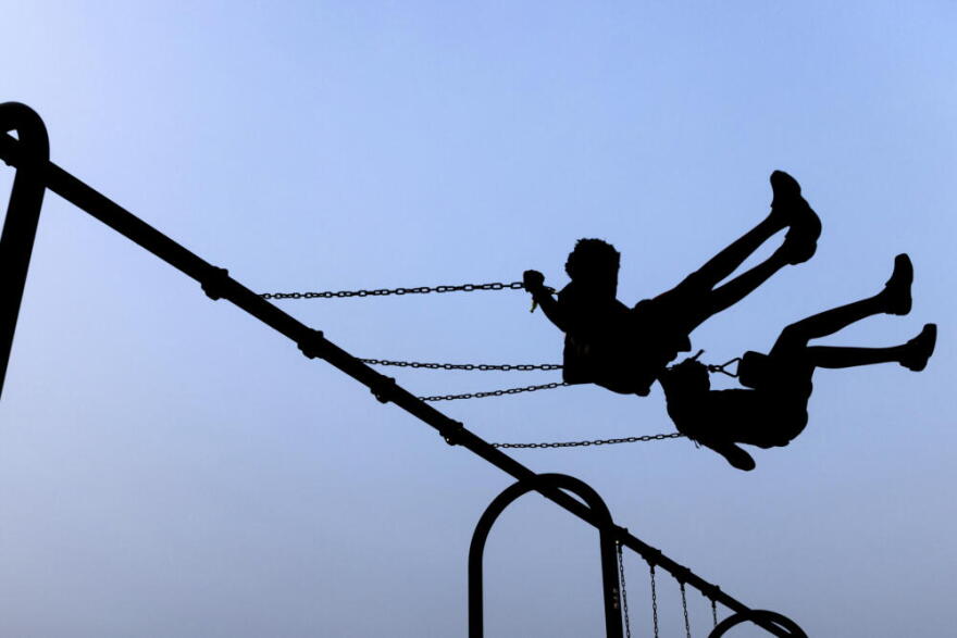 Children play on swings during National Night Out, Tuesday, August 1, 2023, in Salisbury, Maryland. (Julia Nikhinson/AP)