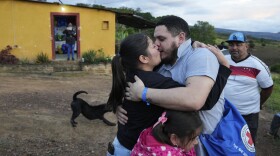 Carlos Uzcategui, one of the Venezuelan migrants deported months ago to El Salvador by the United States under an immigration crackdown, is welcomed home by his wife, Gabriela Mora, in Lobatera, Venezuela, Wednesday, July 23, 2025. (AP Photo/Ariana Cubillos)