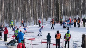 Skiers top the final hill and into the stadium at Birch Hill during a sprint race Tuesday.