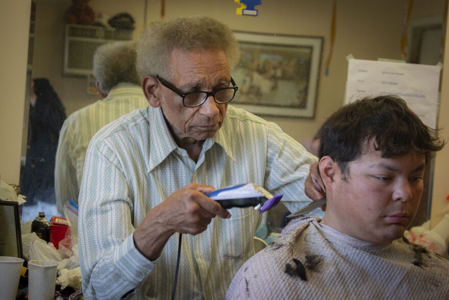 Joe Dinkins cuts hair at his barber shop on April 26, 2026.