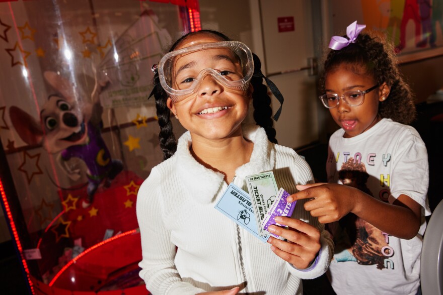 Zoe Shelley and Nah'la Fowler show off the tickets they grabbed in the "ticket blaster" machine at Chuck E. Cheese.